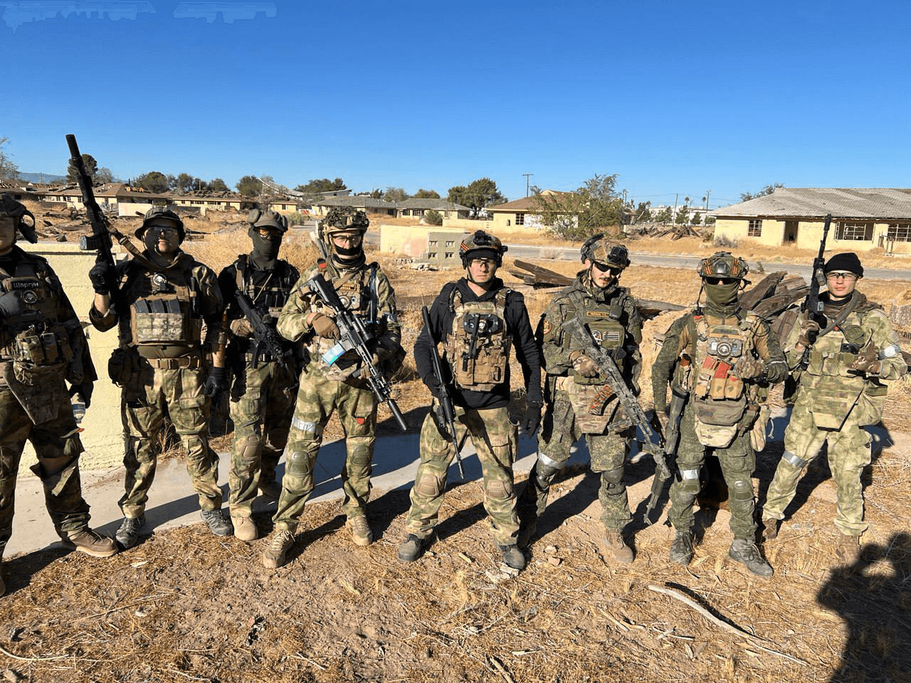 Team of airsoft players posing outdoors
